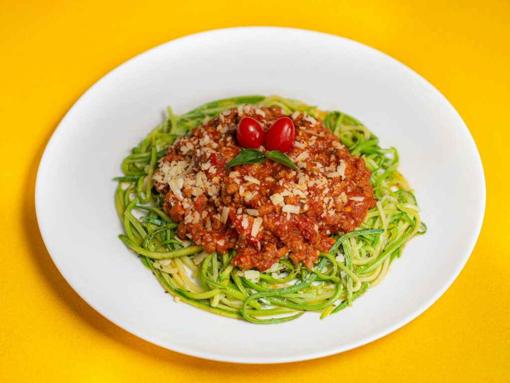 Zucchini Noodles with Bolognese Sauce on White Plate