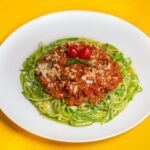 Zucchini Noodles with Bolognese Sauce on White Plate