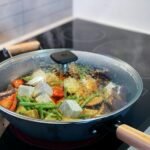 a pan of food cooking on a stove top