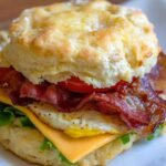 Delicious breakfast biscuit sandwich with bacon, egg, and cheese. Perfect for breakfast lovers.